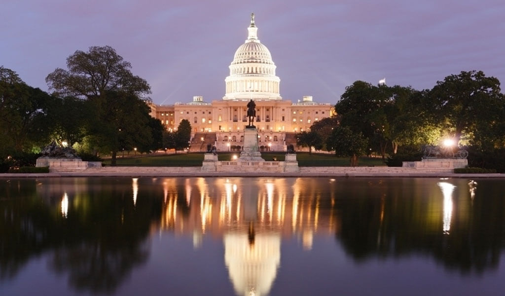 U.S. Capitol building illuminated at dusk.